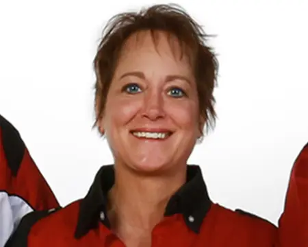 A woman in red shirt smiling for the camera.