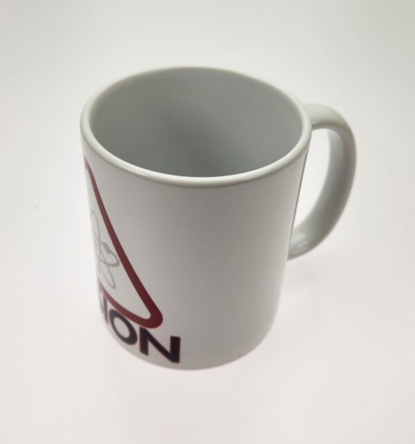 A white coffee mug with the word " caution " written on it.
