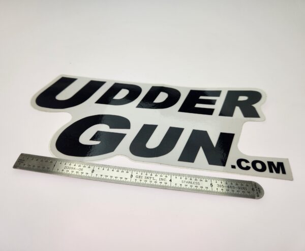 A sticker that says udder gun. Com with a ruler