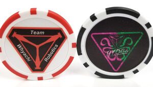 Two poker chips with a team robotics logo on them.
